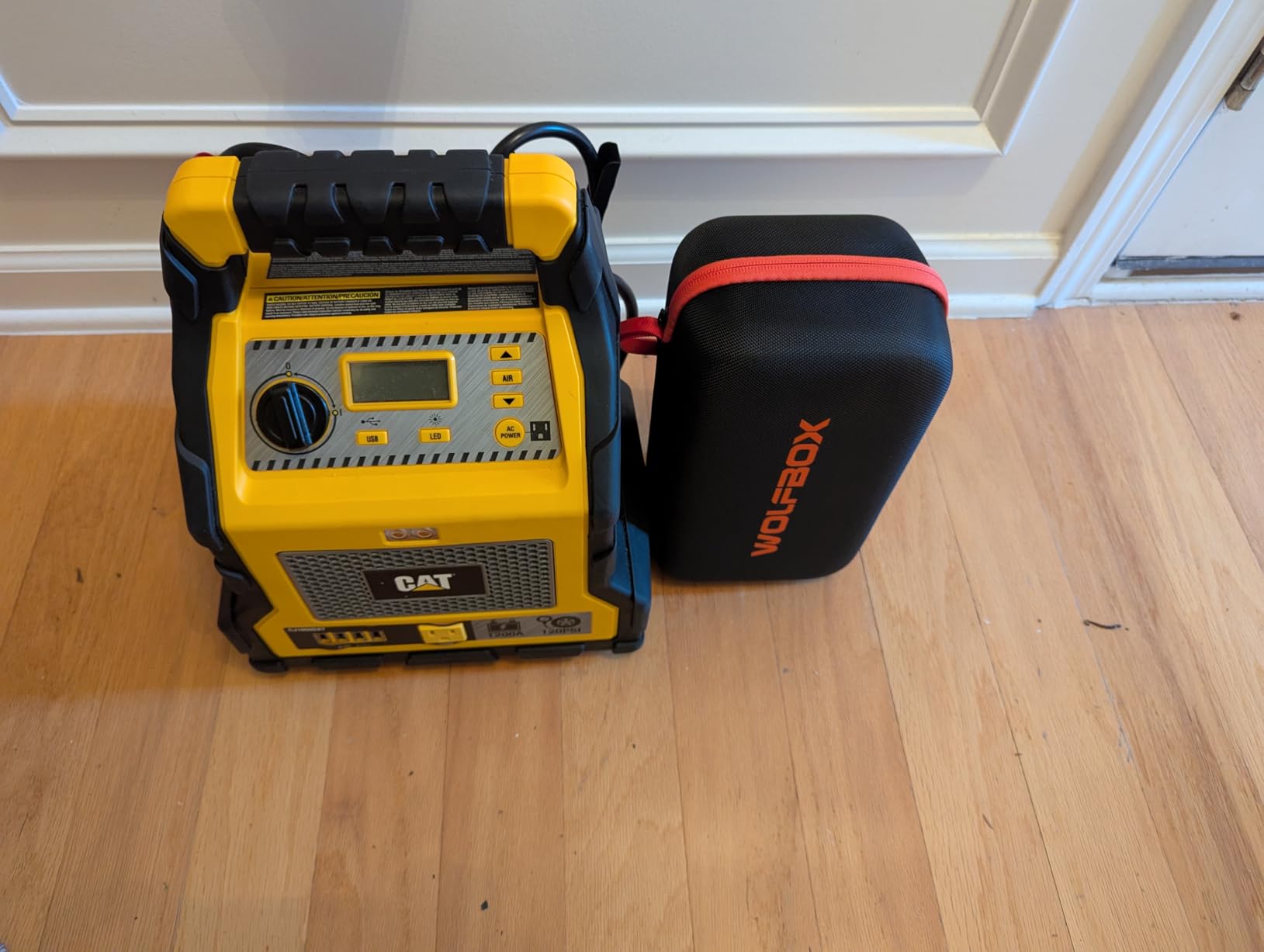 WOLFBOX MV16A jump starting a car battery