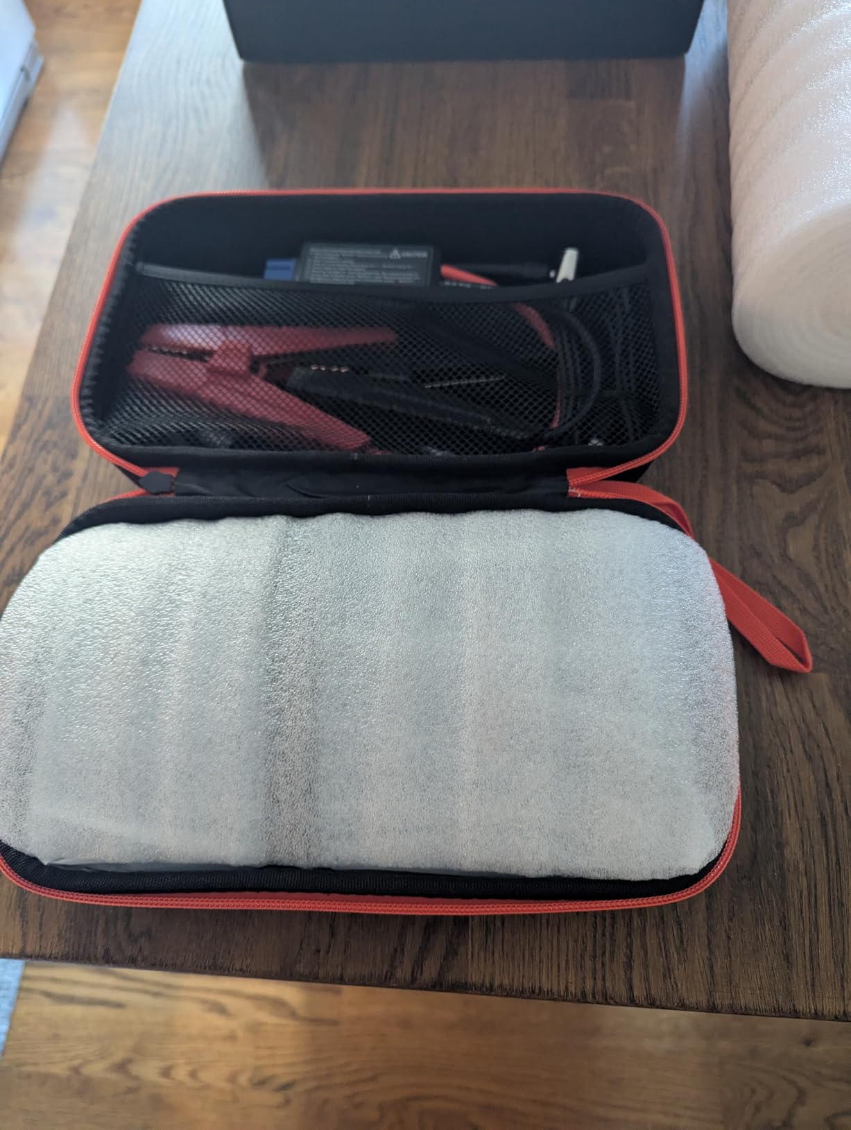 Portable jump starter with air compressor for roadside emergencies